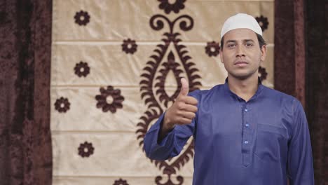 muslim man showing thumbs up with copyspace