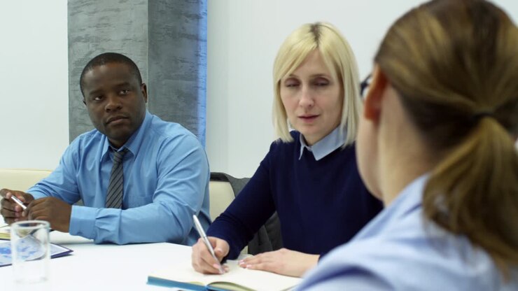 Woman Talking to Diverse Business Partners