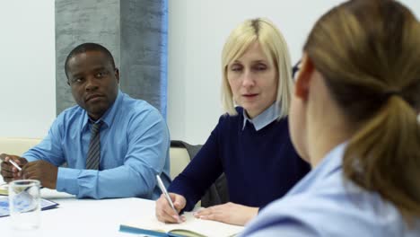 woman talking to diverse business partners