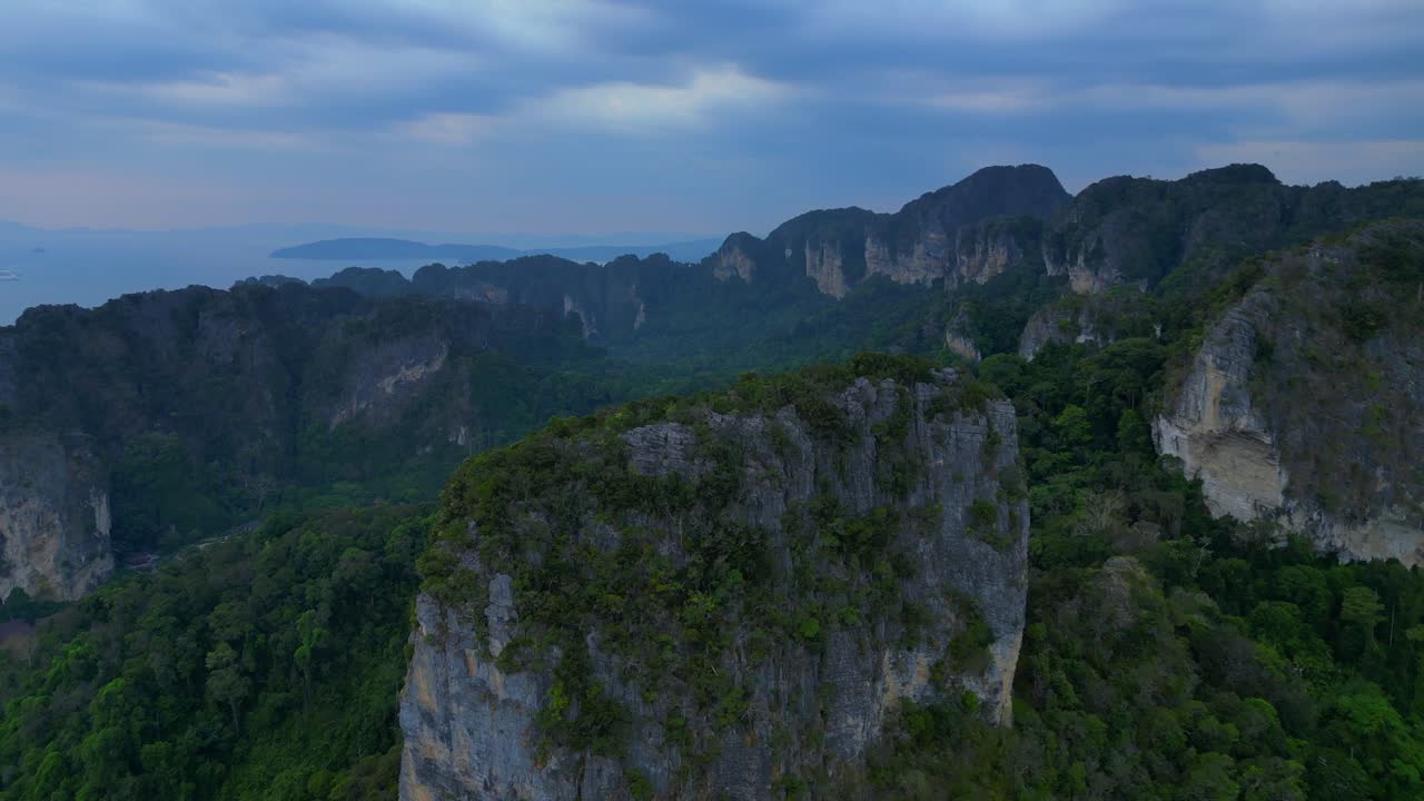 Rai Leh beach towering limestone cliffs emerging from tropical forest in Krabi, Thailand. Majestic aerial view flight overflight flyover drone