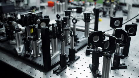 horizontal pan over an optical table with different laser and mirror elements for precise scientific measurements