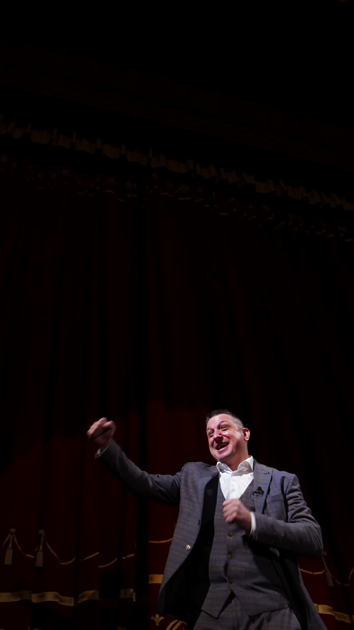 Businessman in theater says about politics and finance. Motivational Speaker. Vertical video