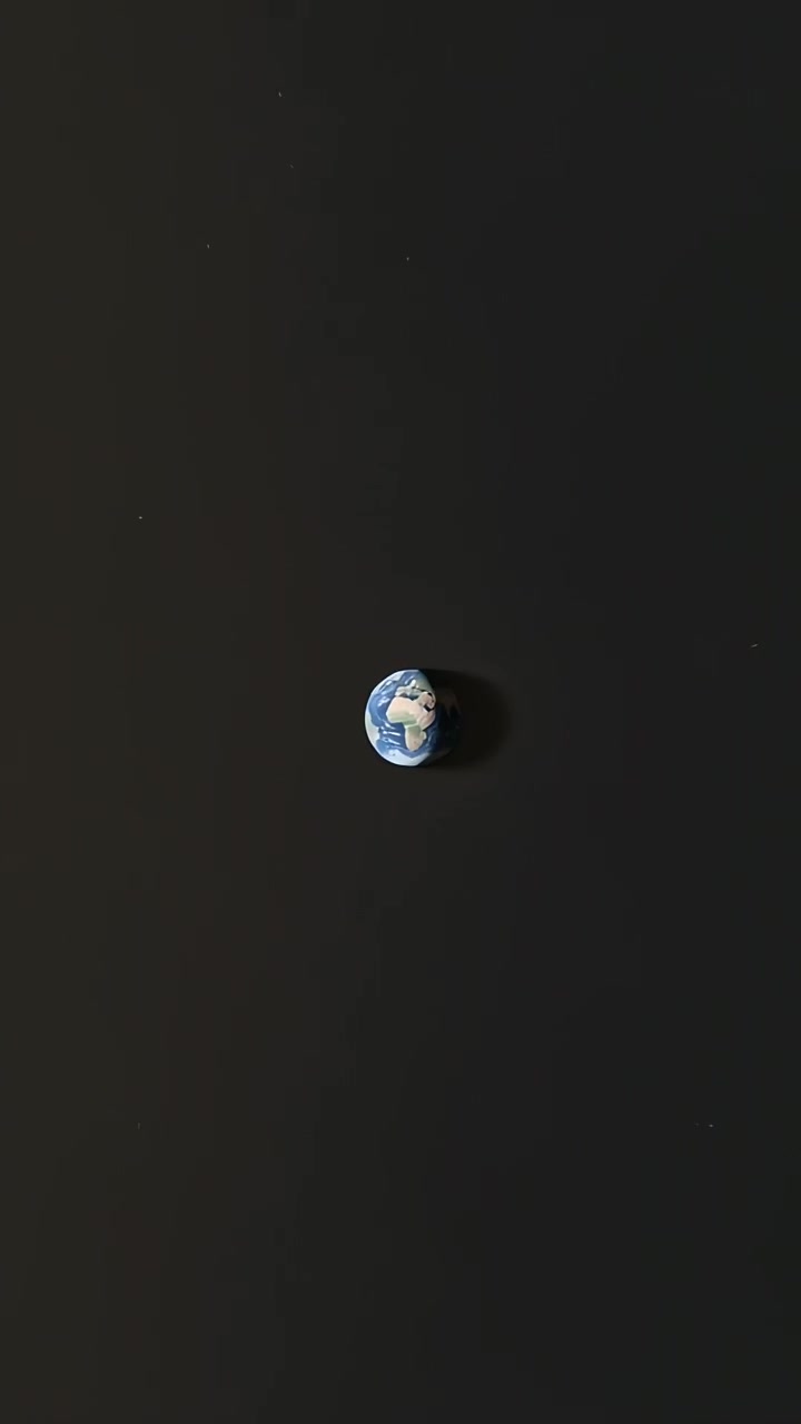 Vertical video: Pulling back revealing globe shrinking in space, Africa visible, showing scale