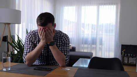 young man at the coffee table tries to pay online with his credit card, but the card is not covered