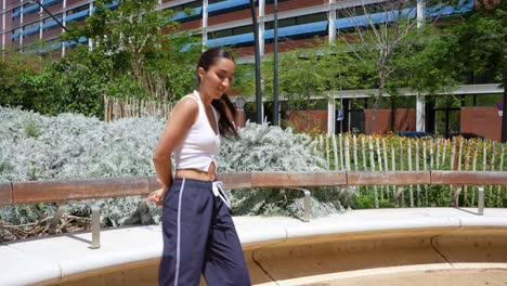 woman dancing outdoors in urban setting