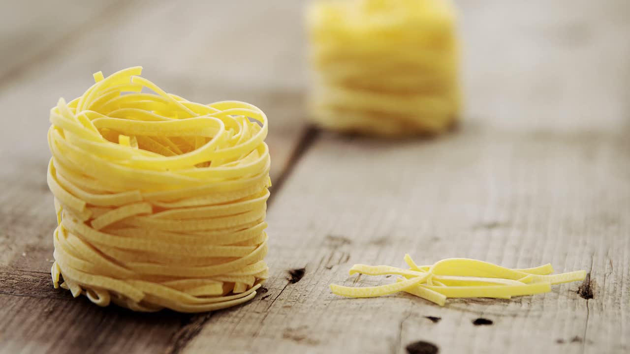 Roll of pasta on wooden table background