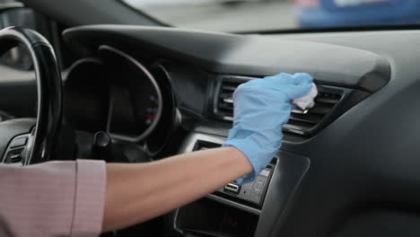 cleaning a car interior with gloves