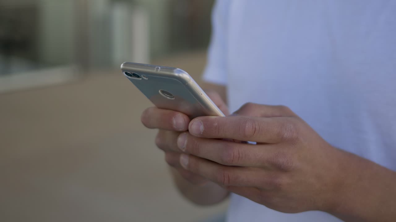 Primo piano di mani maschili che usano lo smartphone