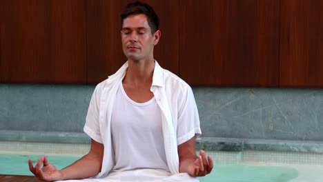 Calm-man-in-white-sitting-in-lotus-pose