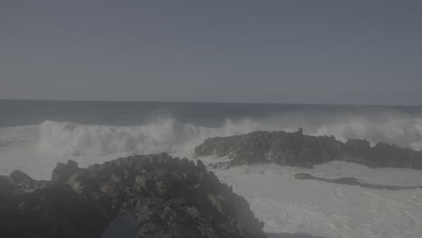 powerful waves crashing on rocky coast