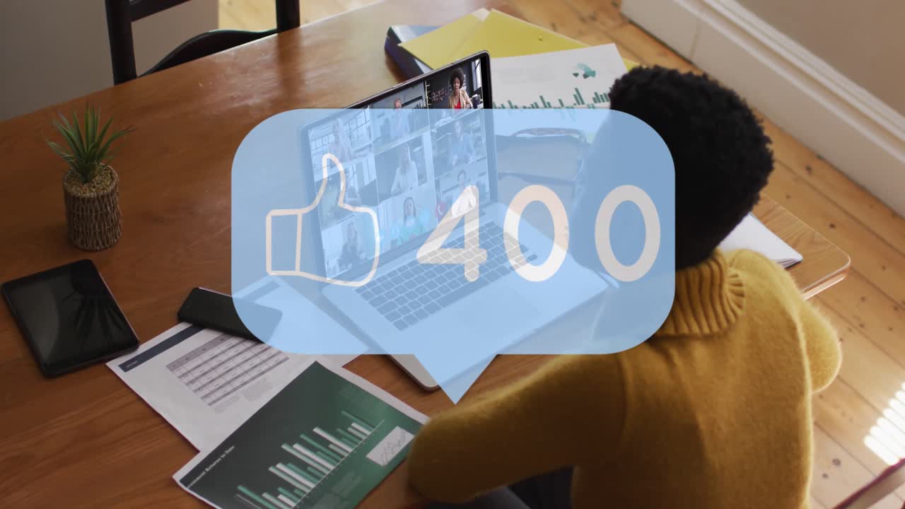 Animation of thumbs up icon and numbers over african american businesswoman using laptop