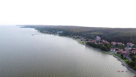 AERIAL-Fly-By-over-the-Curonian-Spit-National-Park-Coastline-and-Juodkrante-in-Lithuania