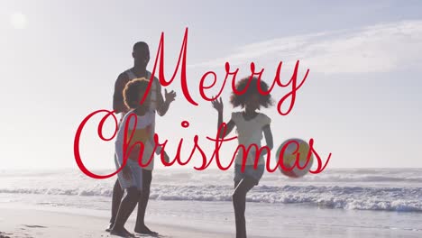 Animation-of-christmas-greetings-text-over-african-american-man-with-son-and-daughter-on-beach