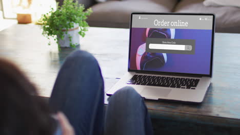 knees of woman at table using laptop, online shopping for gamepads, slow motion