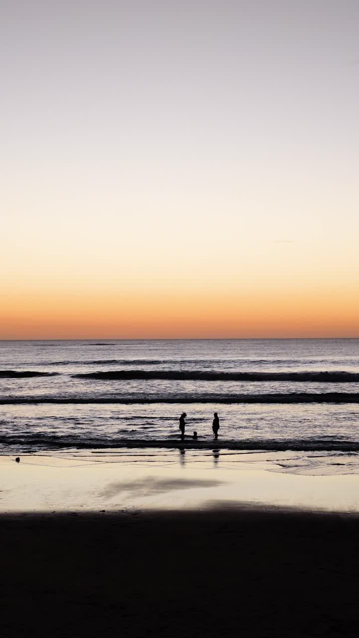 People enjoying the beach at sunset