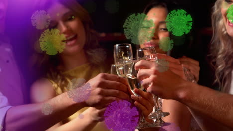 digital composite video of covid-19 cells moving against group of women making a toast