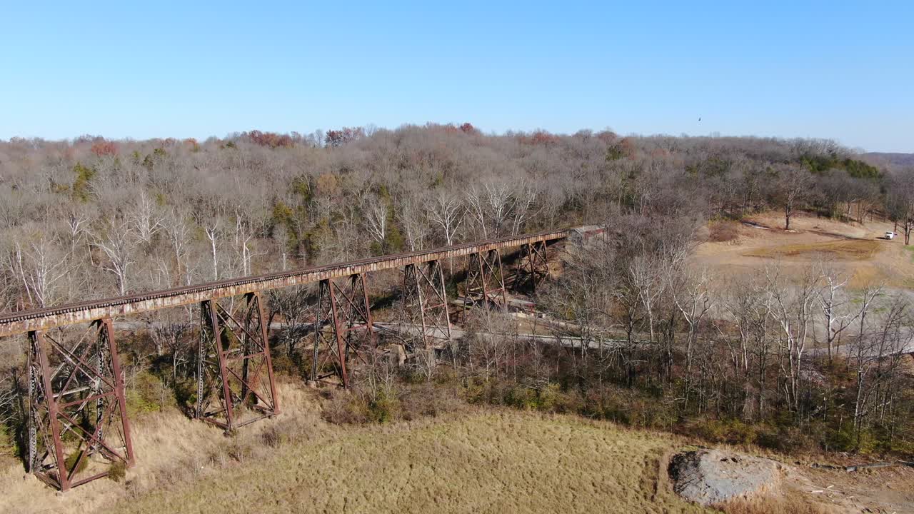 Aerial Shot Pushing Across a Field Towards the Pope Lick Railroad Trestle in Louisville Kentucky on a Sunny Afternoon