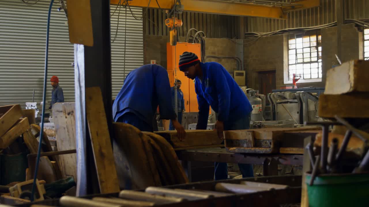 Male worker arranging molds in workshop 4k