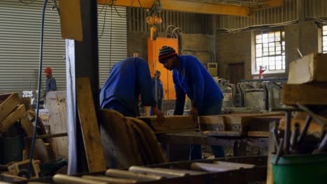 male worker arranging molds in workshop 4k