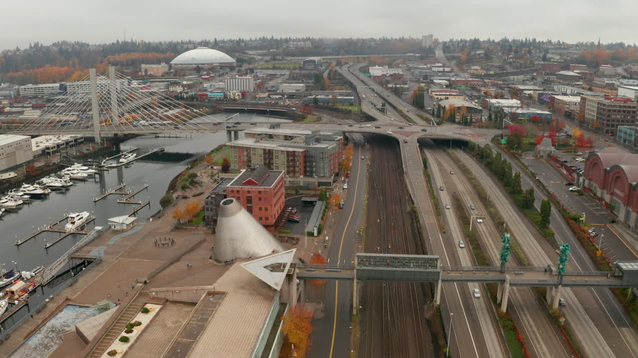 Arcing aerial shot of downtown  port city on a foggy day, Tacoma, Washington