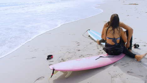 surfer couple romancing on the beach 4k 4k