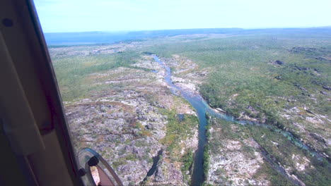 light aircraft flying towards river valley kakadu national park northern territory australia