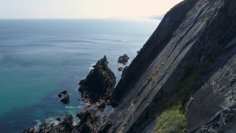 A-drone-shot-of-the-rugged-coastal-terrain-of-the-Dingle-Peninsula,-near-Dingle-Point,-in-Ireland