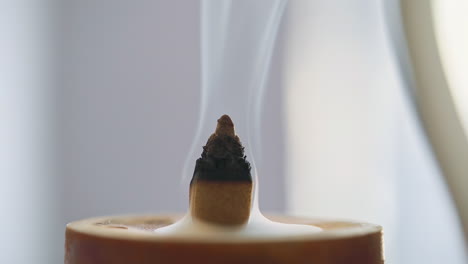 close-up of flower bud-shaped agarwood incense burning a half way