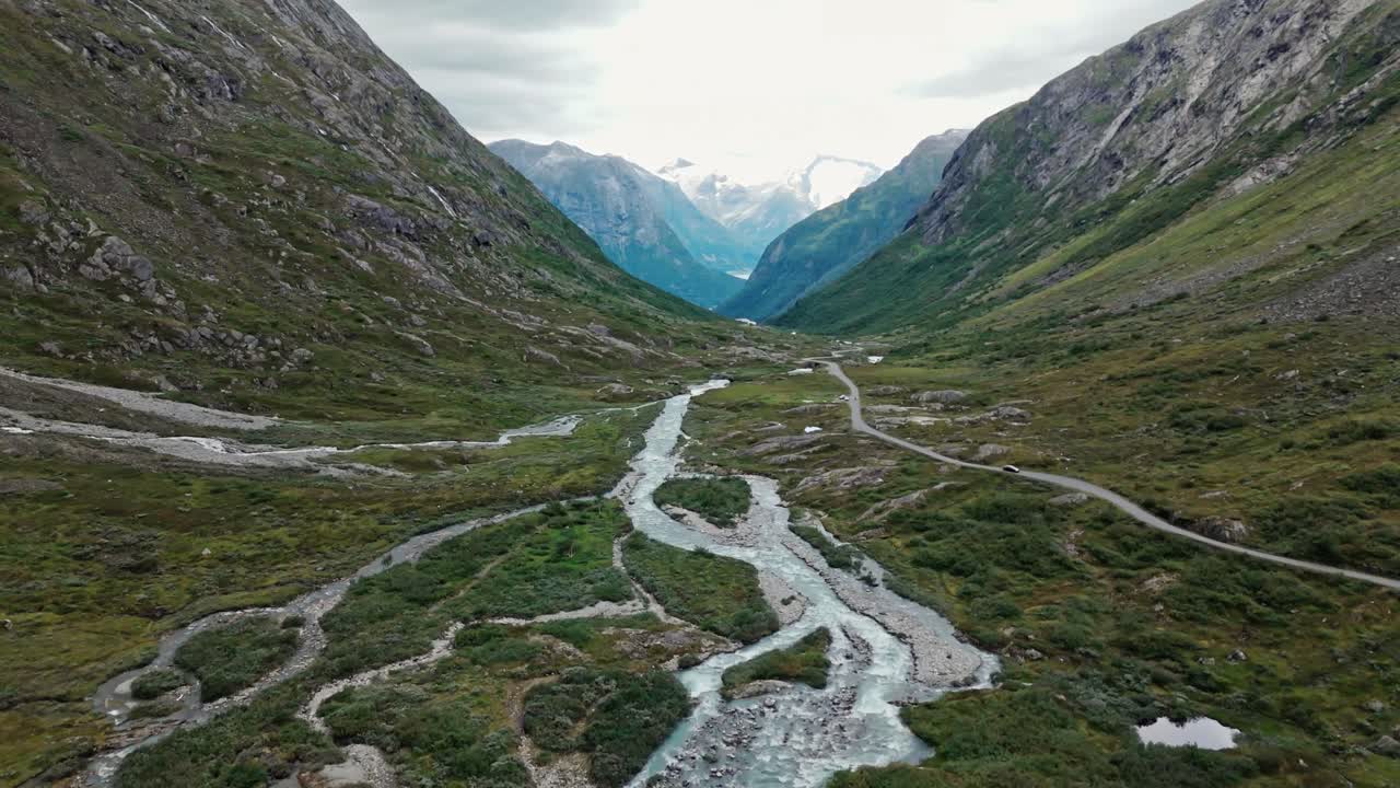 Aerial View of a Serene Mountain Valley with a Winding River