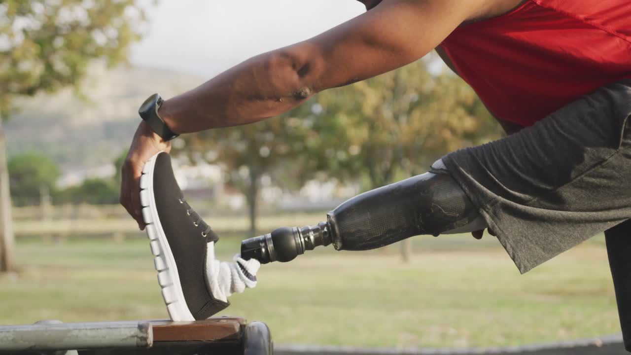 Side view man with prosthetic leg stretching