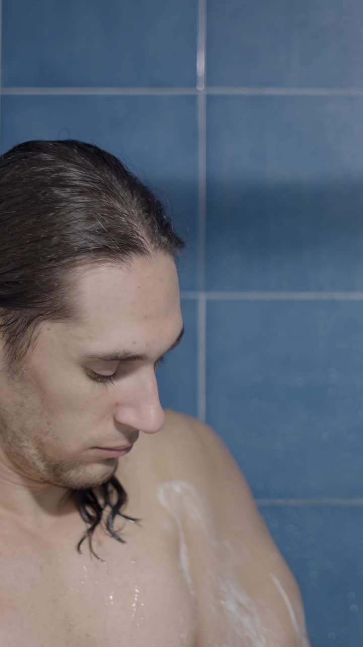A man washing himself in a shower