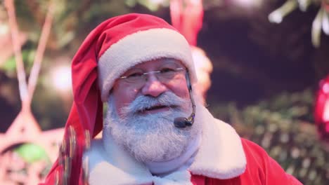positive kind santa claus talking to the audience into a microphone standing on a bright christmas positive kind santa claus talking to the audience into a microphone standing on a bright christmas background waving a wand new years santa claus wishes people a happy new year and christmas
