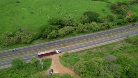 aerial: flying above a big rig 18-wheeler driving down the panamerican highway.