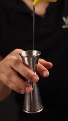 bartender measuring liquor