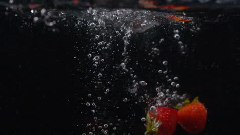 Sweet-Refreshing-Beautiful-Strawberries-Drop-in-Water-with-Bubbles-Food-in-Slow-Motion