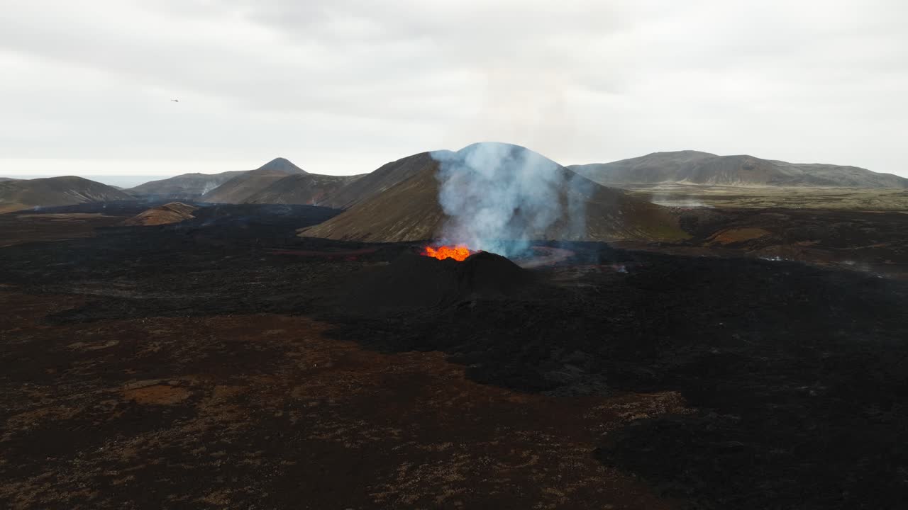 Aerial landscape view over the volcano erupting at Litli-Hrutur, Iceland, with lava and smoke coming out