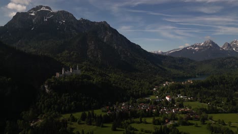 drone rising high towards historical neuschwanstein castle in schwangau bayern, germany