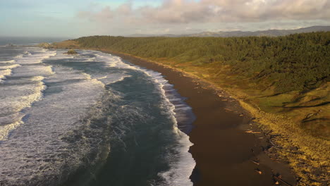 aerial flying backwards over southern oregon coast at golden hour