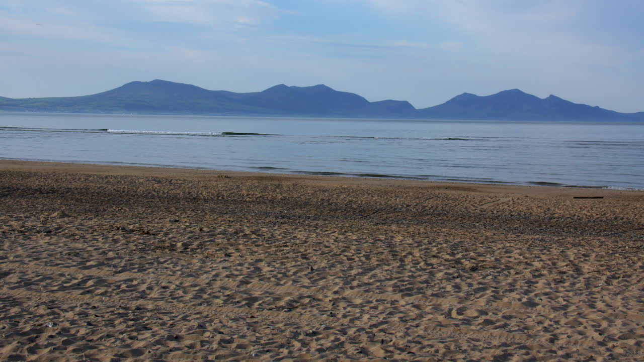 wide shot of Llanddwyn beach with Mountains of Lleyn peninsula in background at the Newborough National Nature Reserve