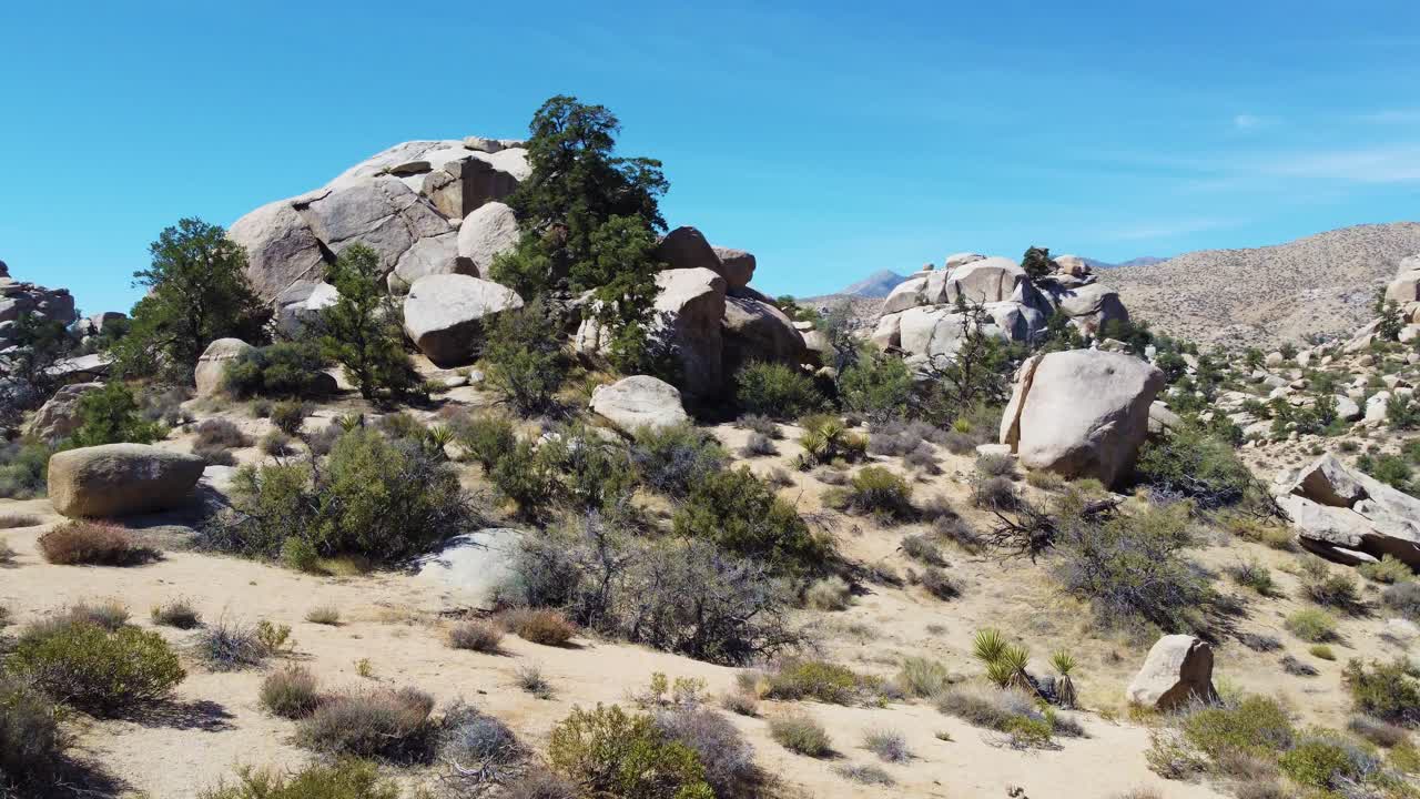 Low altitude flying over rocky desert terrain, drone view