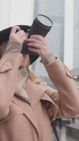 woman taking photos in the city