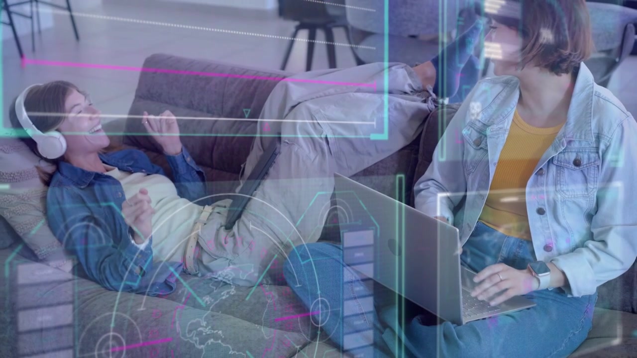 Reclining woman on couch with headset gesturing, seated user typing causing tech HUD charts for fun