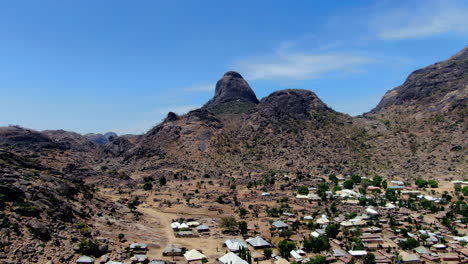 a suburb of the city of dass nestled beneath the rugged mountains of the nigerian state of bauchi - aerial pull back view