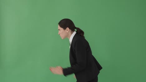 businesswoman running over green background