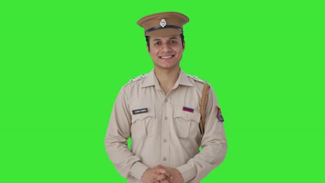 happy indian police officer smiling to the camera green screen