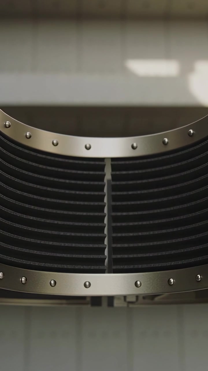 Vertical video: Activating riveted cylinder moving panels exposing black fin stack on tiled wall