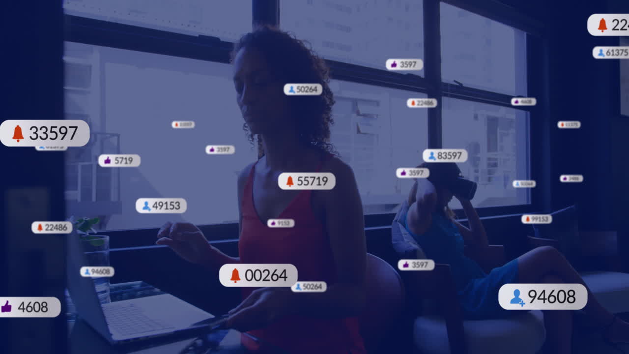 Animation of social media notifications over diverse women using smartphones at casual office