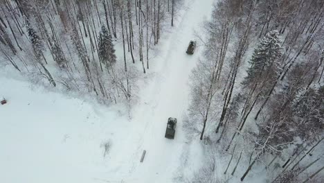 military vehicles in a snowy forest