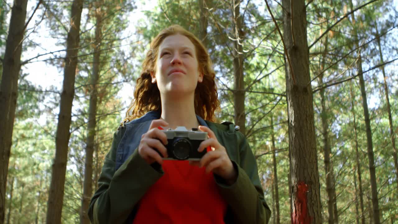 Woman clicking photo with camera 4k