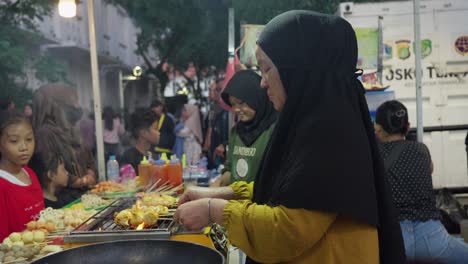 street food vendor grilling meatballs
